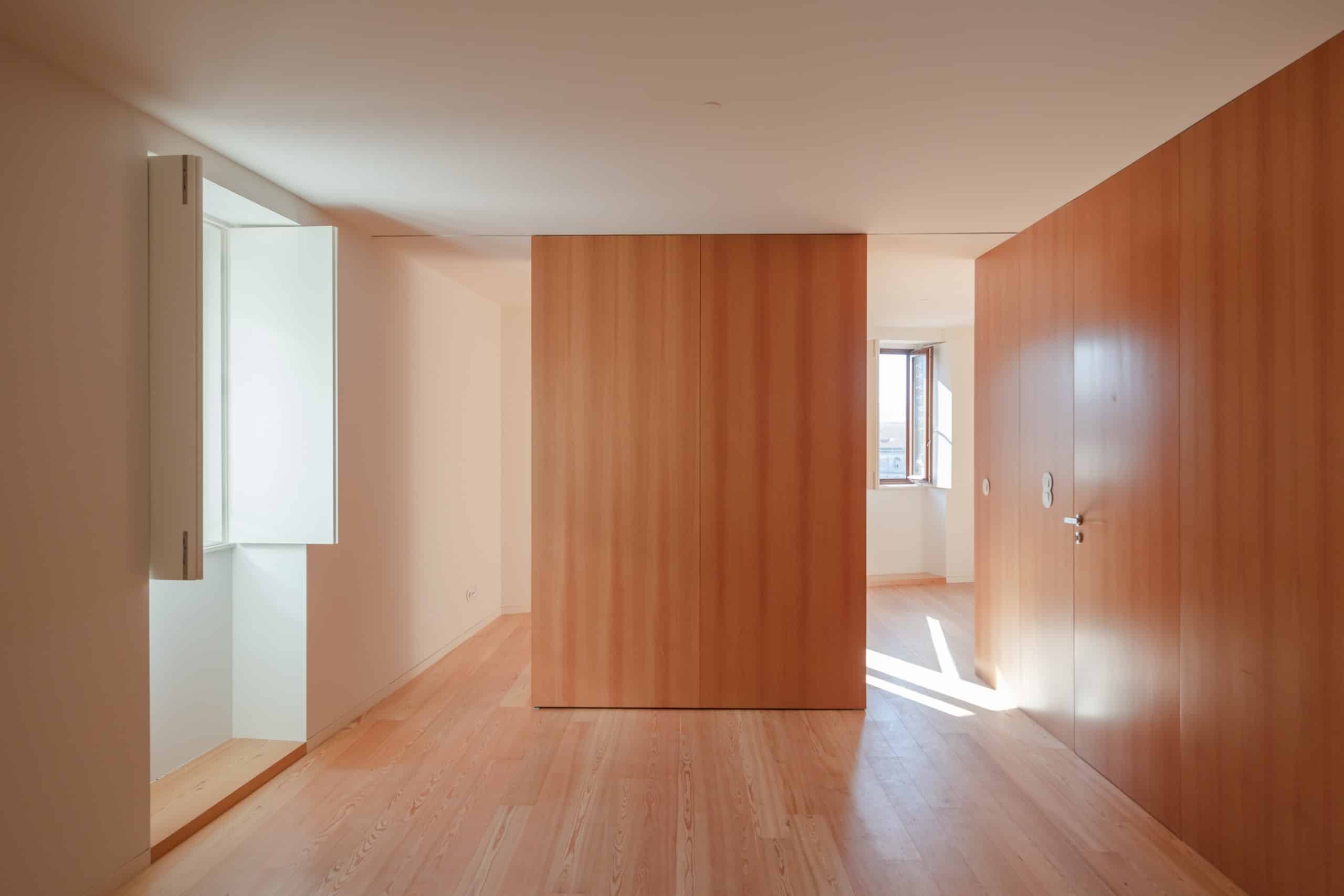 Nicht nur außen, sondern auch innen spielt Holz eine große Rolle bei der Gestaltung. Die Farbe erinnert an die rötlichen Dachziegel. Foto: © OODA